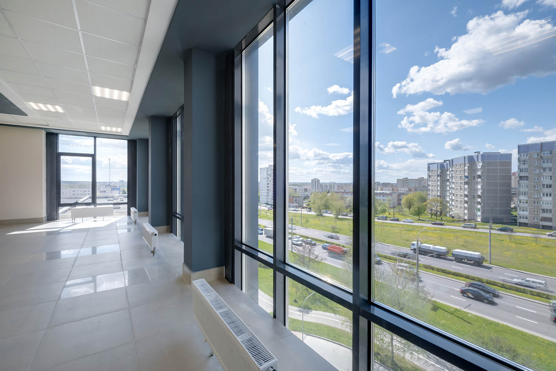 empty modern hall room with columns, doors and panoramic windows