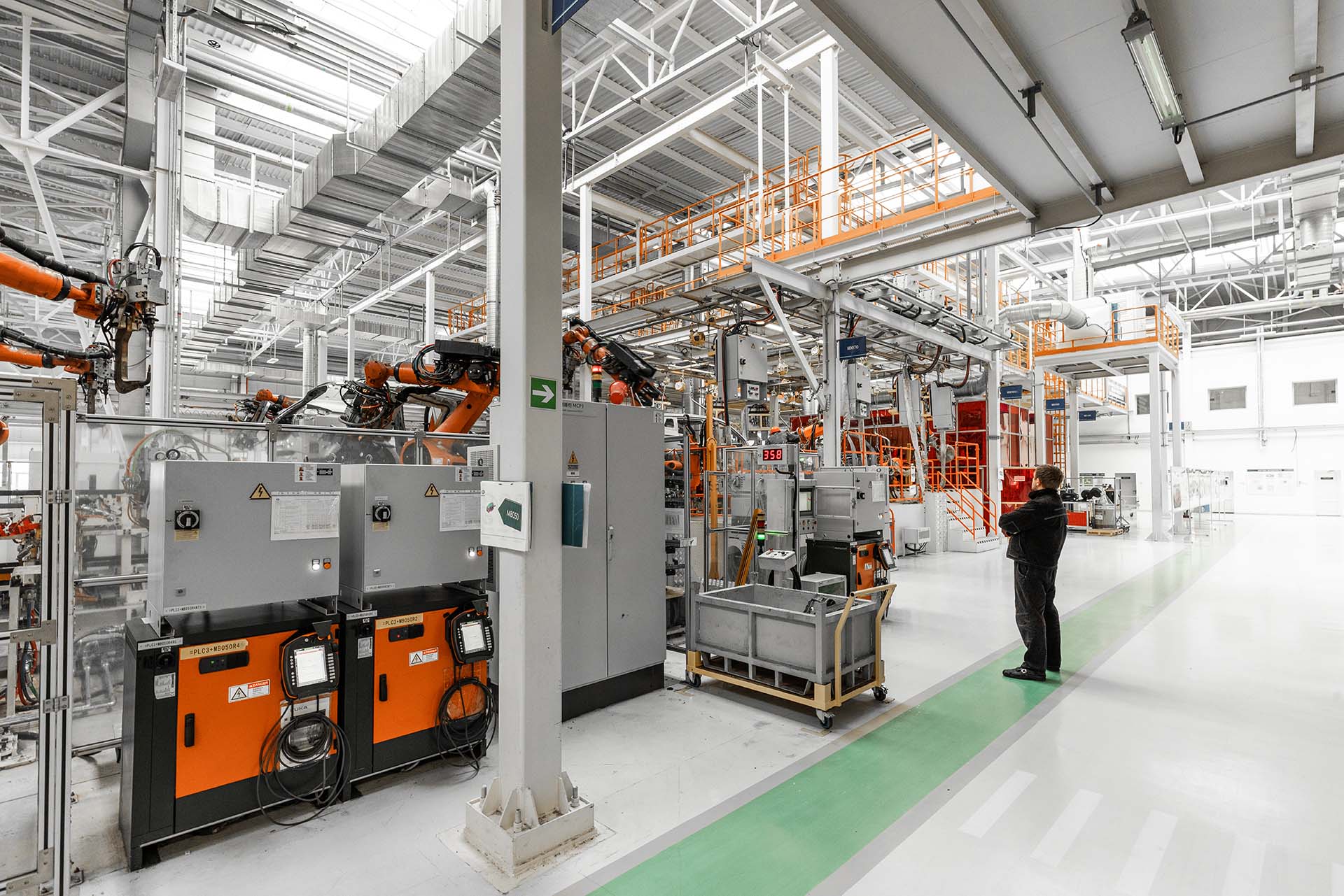 Photo of automobile production line. Welding car body. Modern car assembly plant. Auto industry. Interior of a high-tech factory, modern production