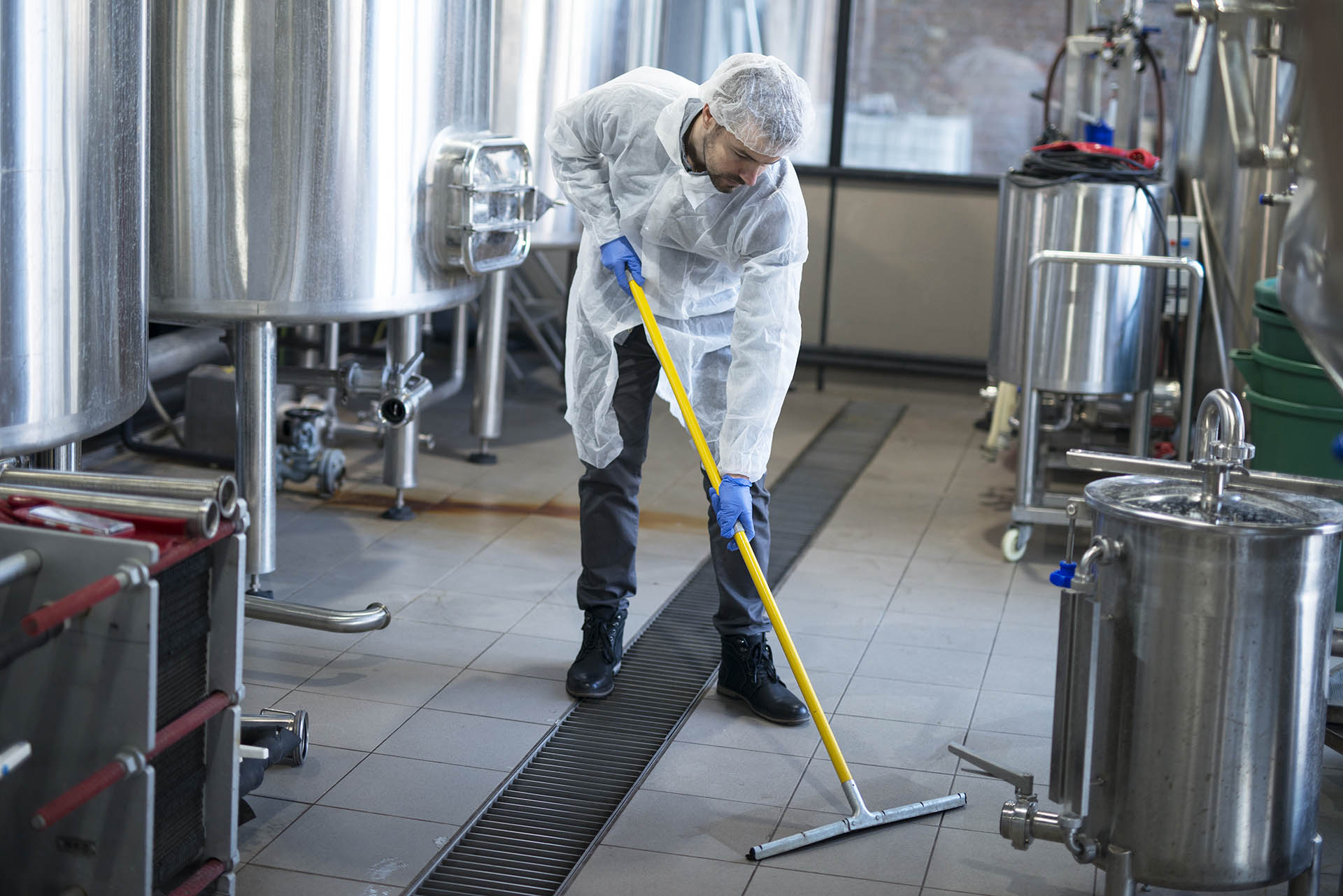 Professional cleaner wearing protection uniform cleaning floor o